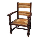 Fauteuil en  chêne teinté et paille, travail français 1950
