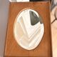 Bevelled oval mirror on oak frame