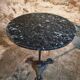 Old French bistro table with a marble top and a cast iron base.