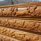 Compact 4-drawer ethnic chest of drawers carved with scenes of African life