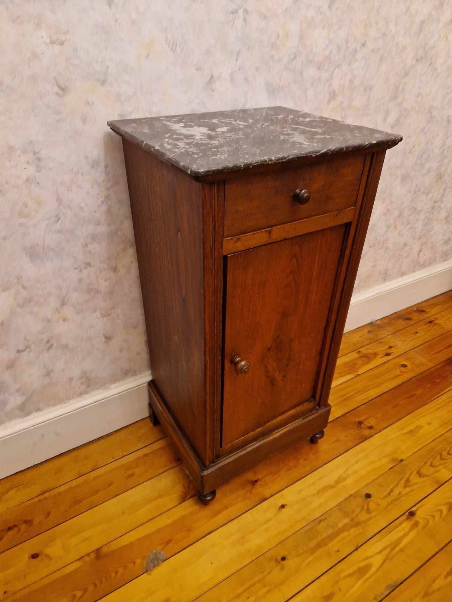 Antique wooden bedside table with black marble top