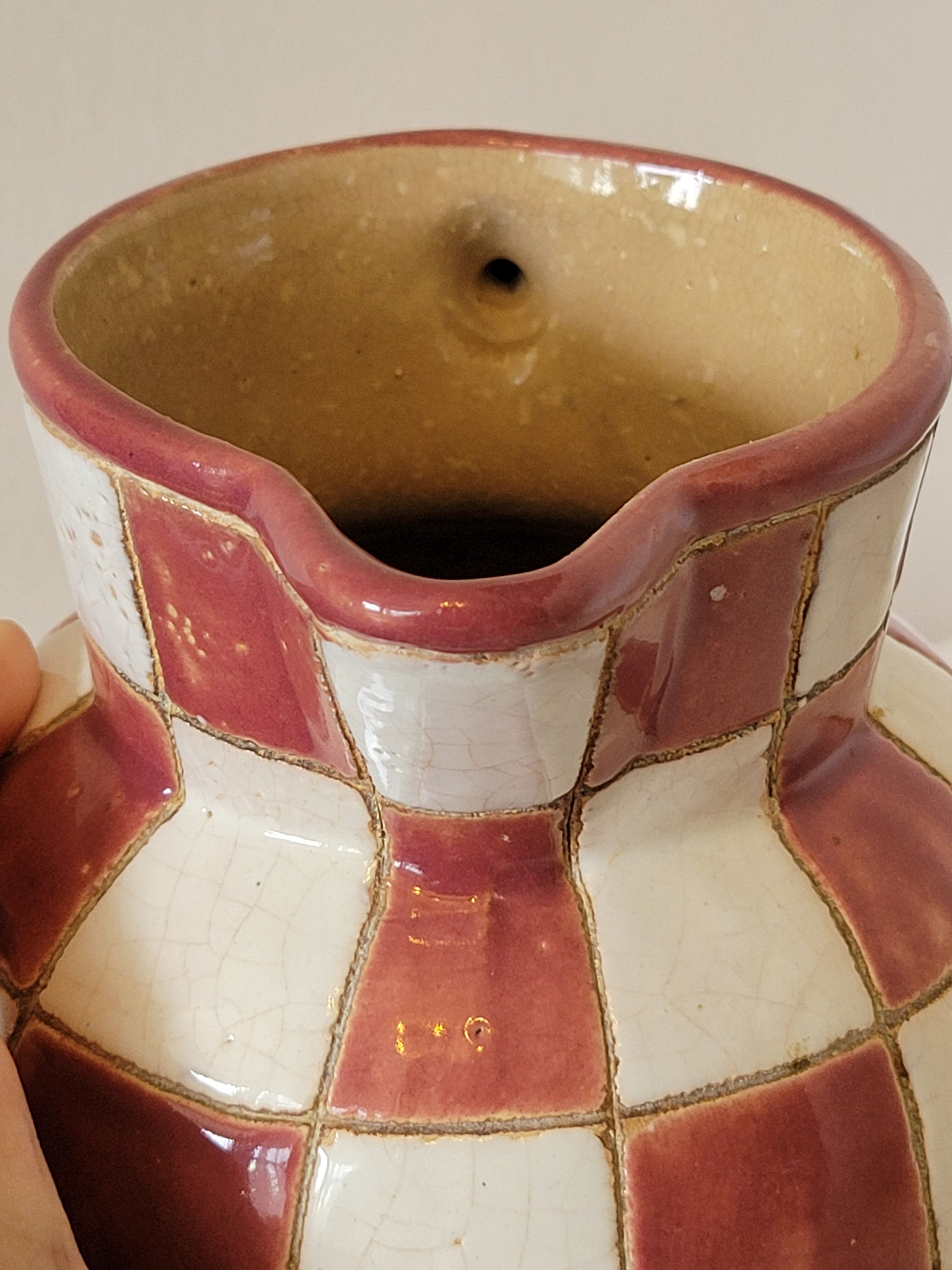 Old ceramic pitcher pattern checkerboard tiles