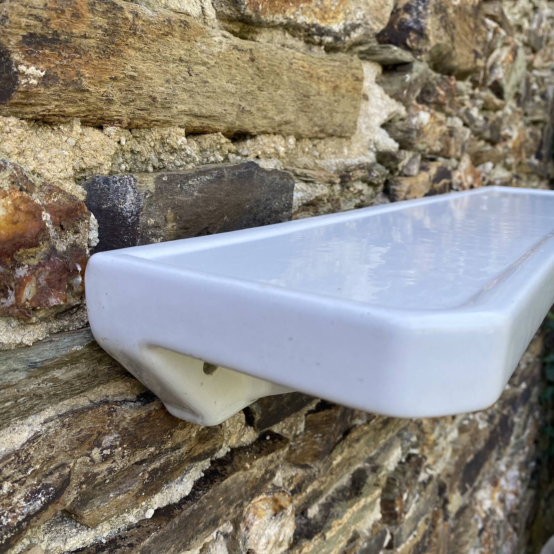 Antique wall shelf for bathroom in white porcelain.