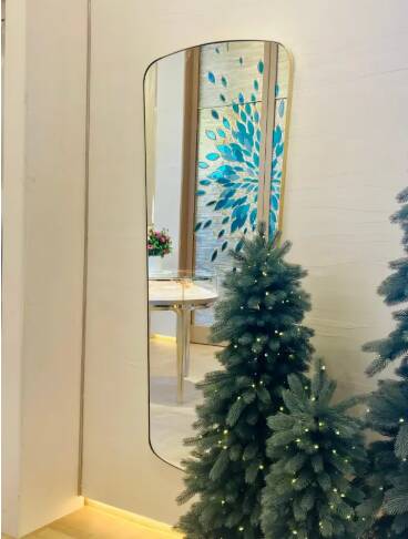 Contemporary rectangular mirror with rounded edges and embossed brass frame, large.