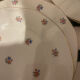 Dessert plate and porcelain dishes with a multicoloured floral pattern, vintage.
