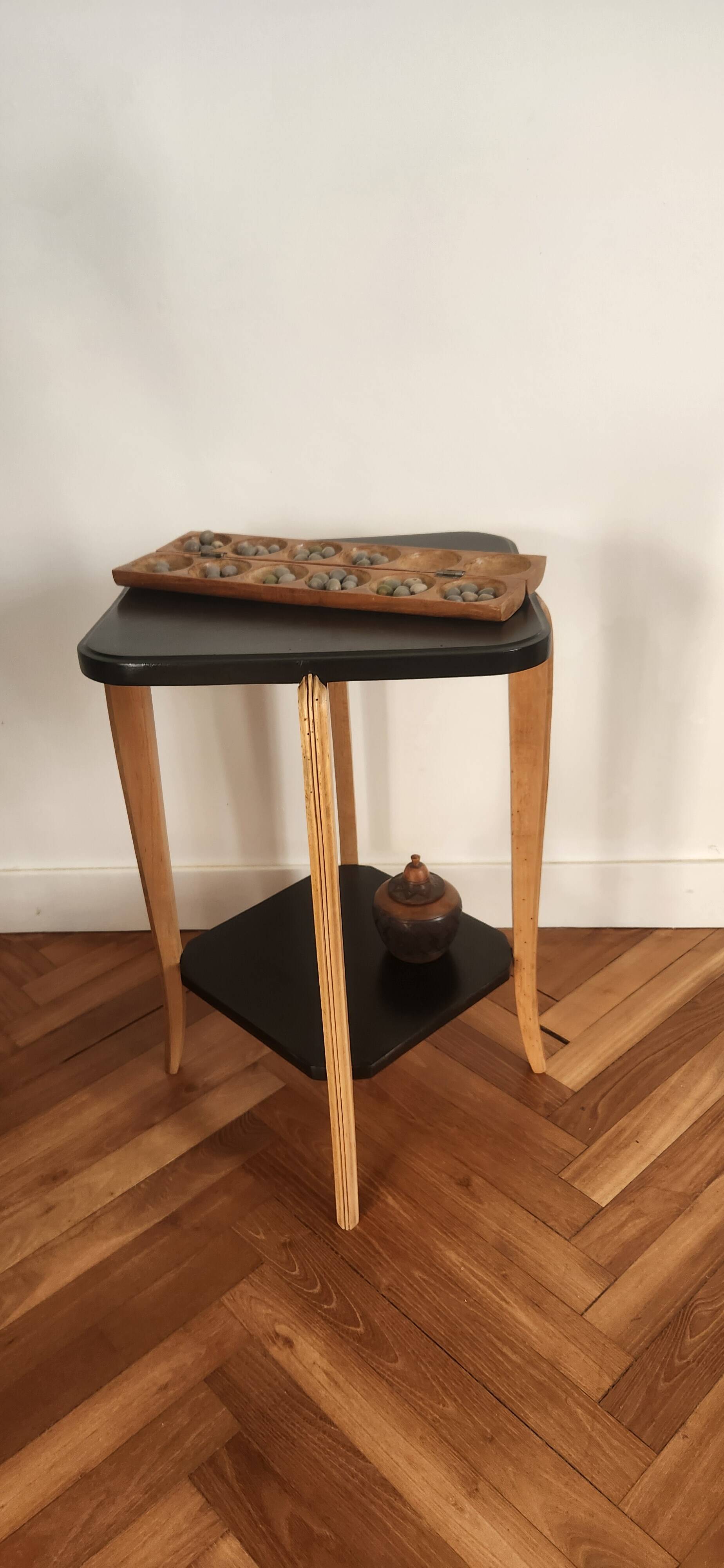 Black lacquered wooden side table with offset tops.