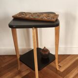 Black lacquered wooden side table with offset tops.