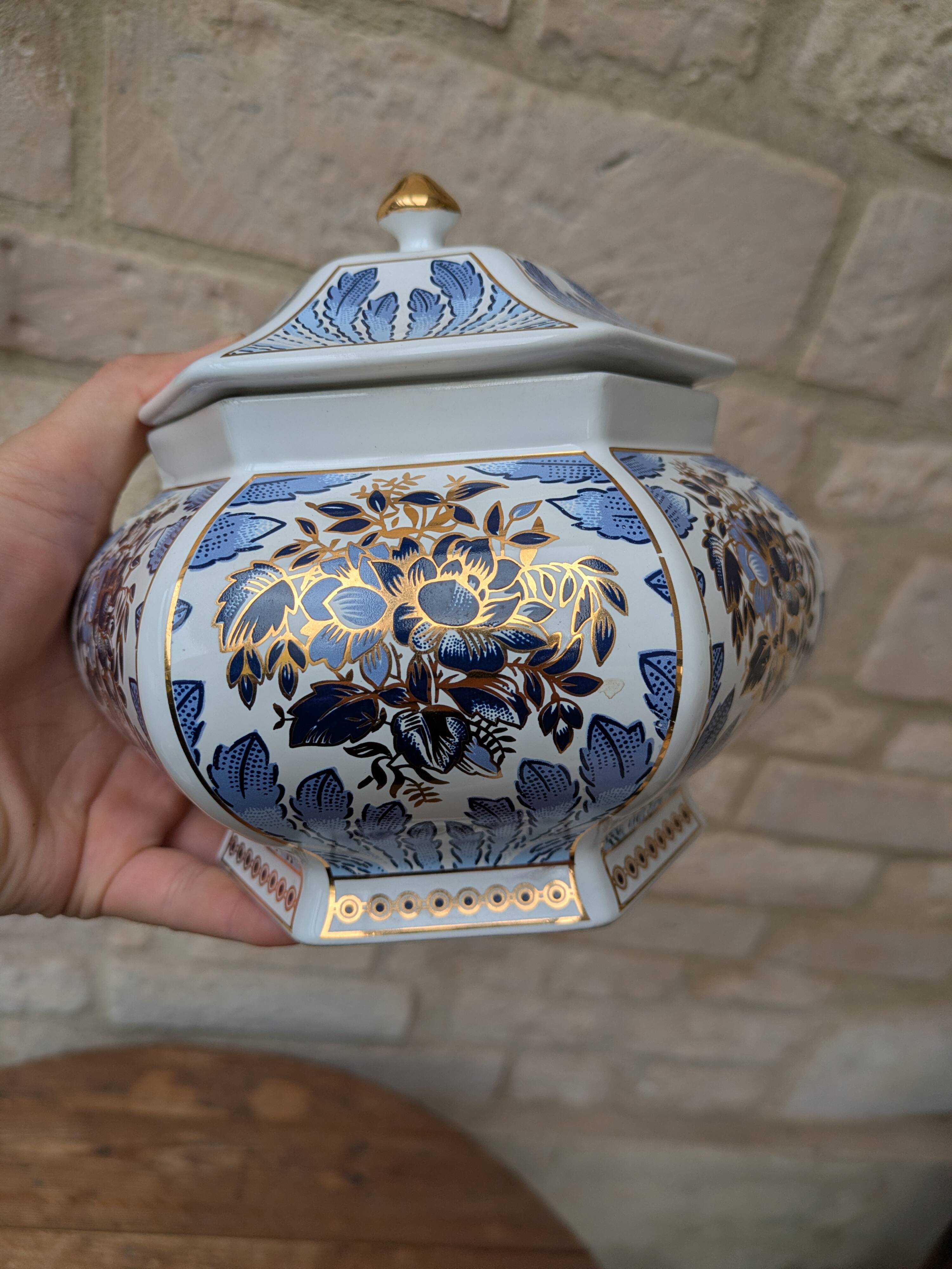 Decorative pot jar with a lid featuring a blue floral pattern and gilding.