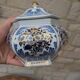 Decorative pot jar with a lid featuring a blue floral pattern and gilding.