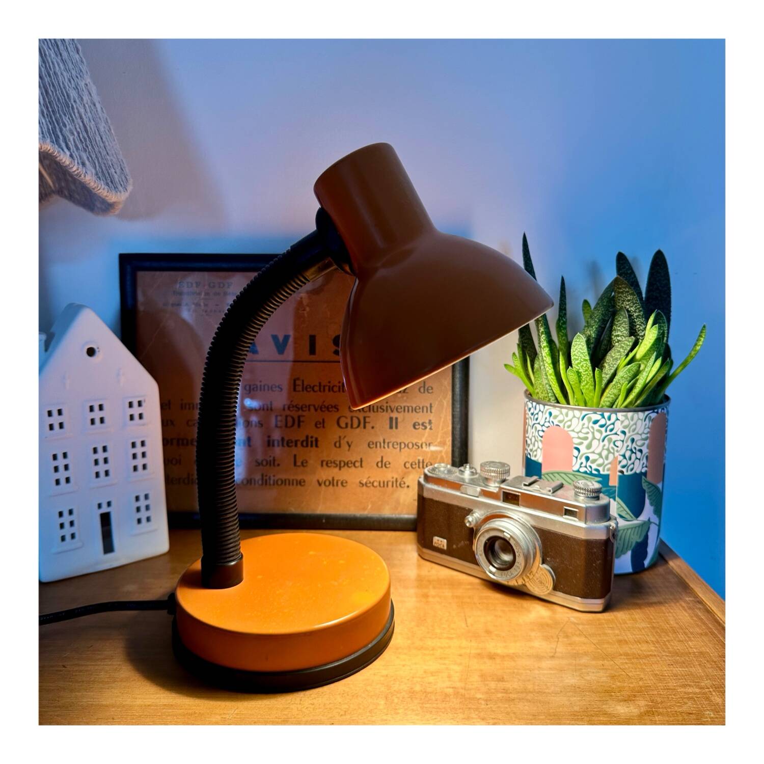 Orange articulated desk lamp
