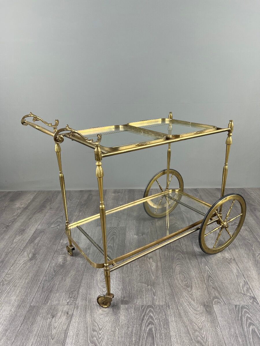 Rolling table cart in gilded brass with two glass shelves, 20th century.