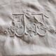 Antique embroidered linen sheet with a monogram.