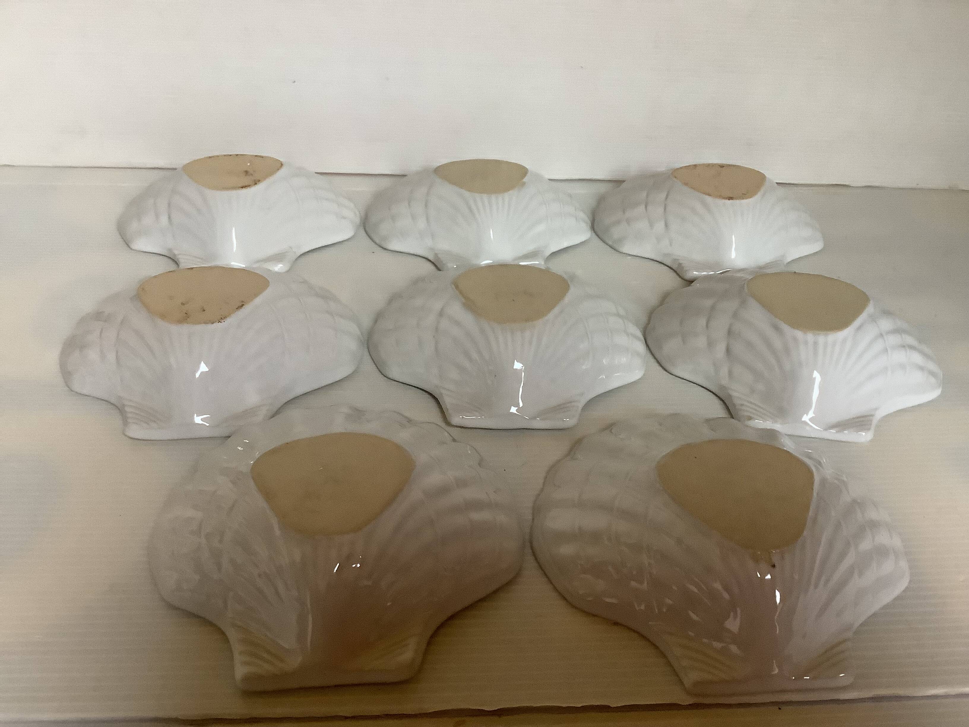 Eight white scallop shell bowls