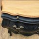 Curved commode painted in black and wood.