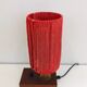 Small lamp made of wood, brass, and wool.