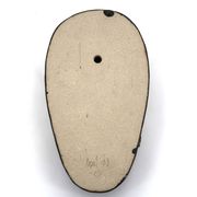 Wall sculpture, stylised mask signed in ceramic.