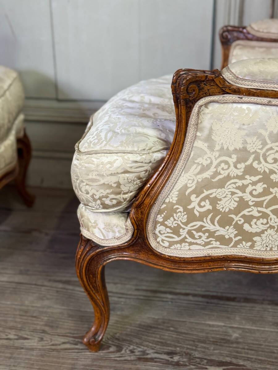 Pair of small Louis XV style wing chairs in carved walnut, Bosson stamp