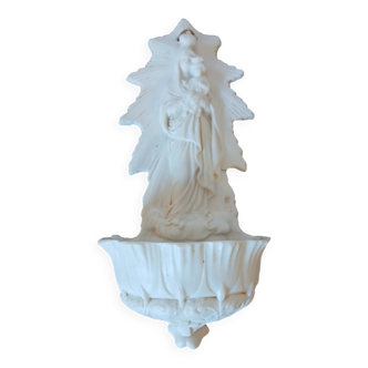 Biscuit holy water font representing a virgin and child
