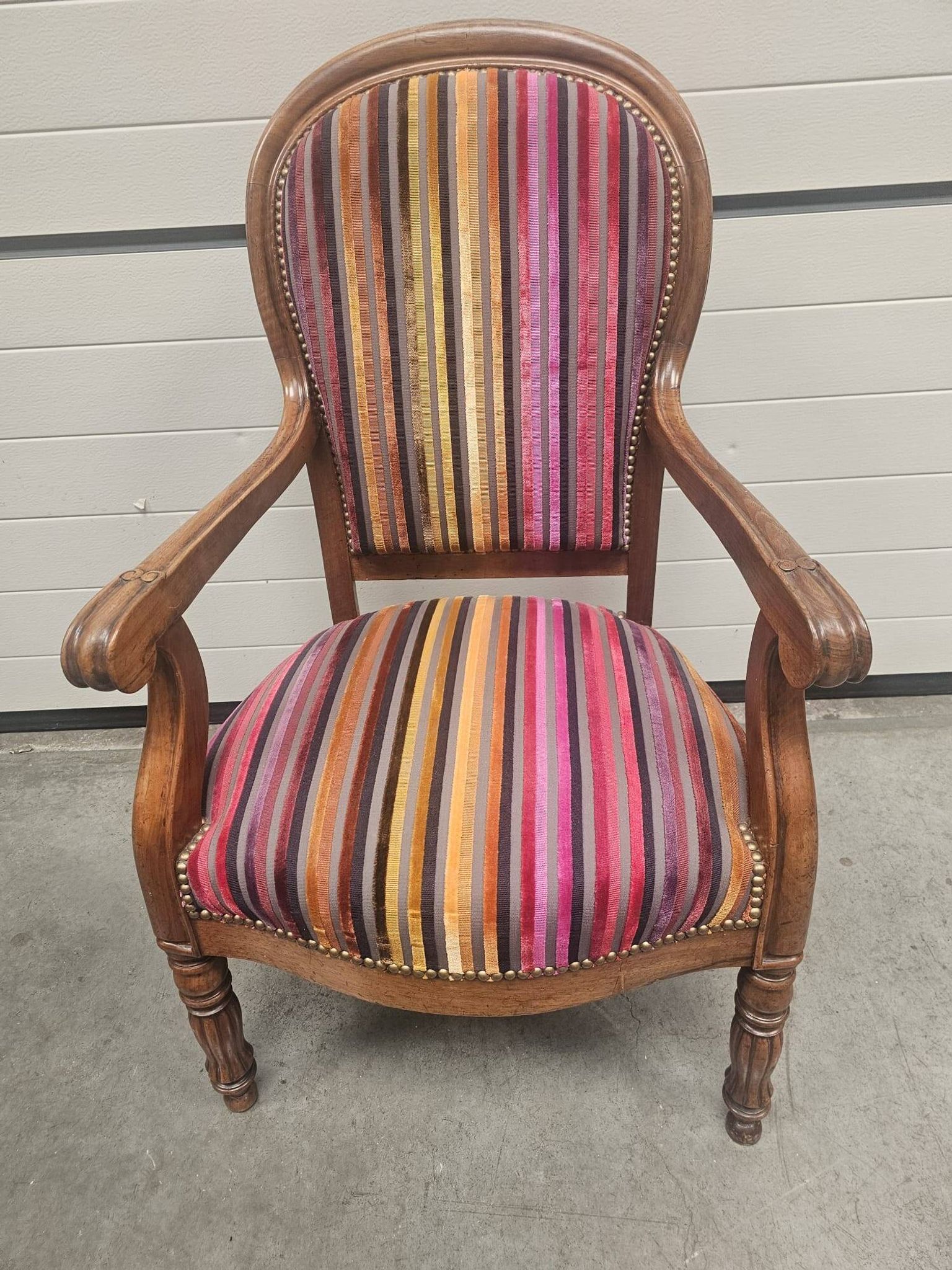 Antique striped multicoloured velvet armchair with turned legs.