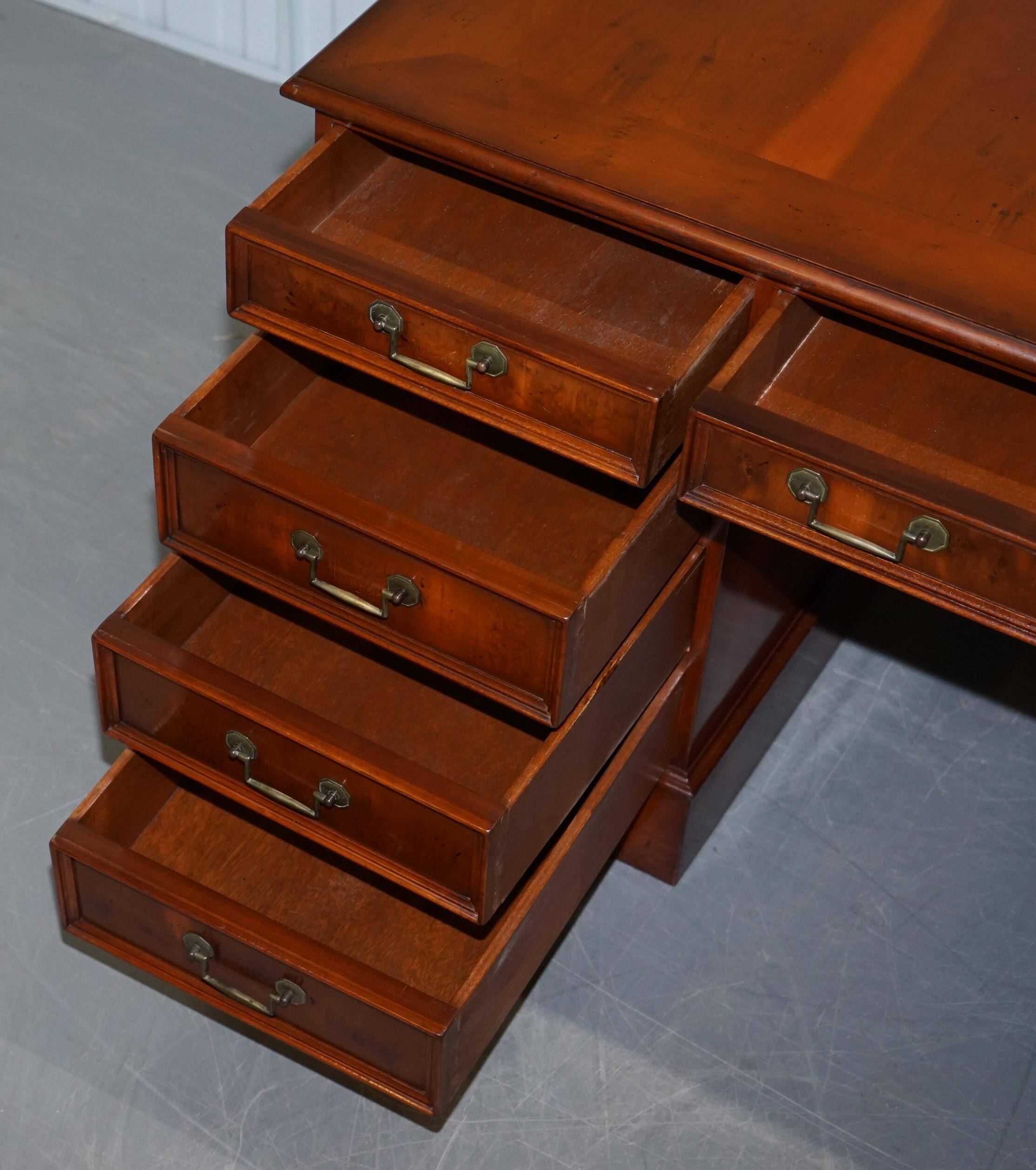 Partner desk with double pedestal in burr yew wood with decorated top.