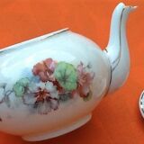 Old porcelain teapot with floral decoration