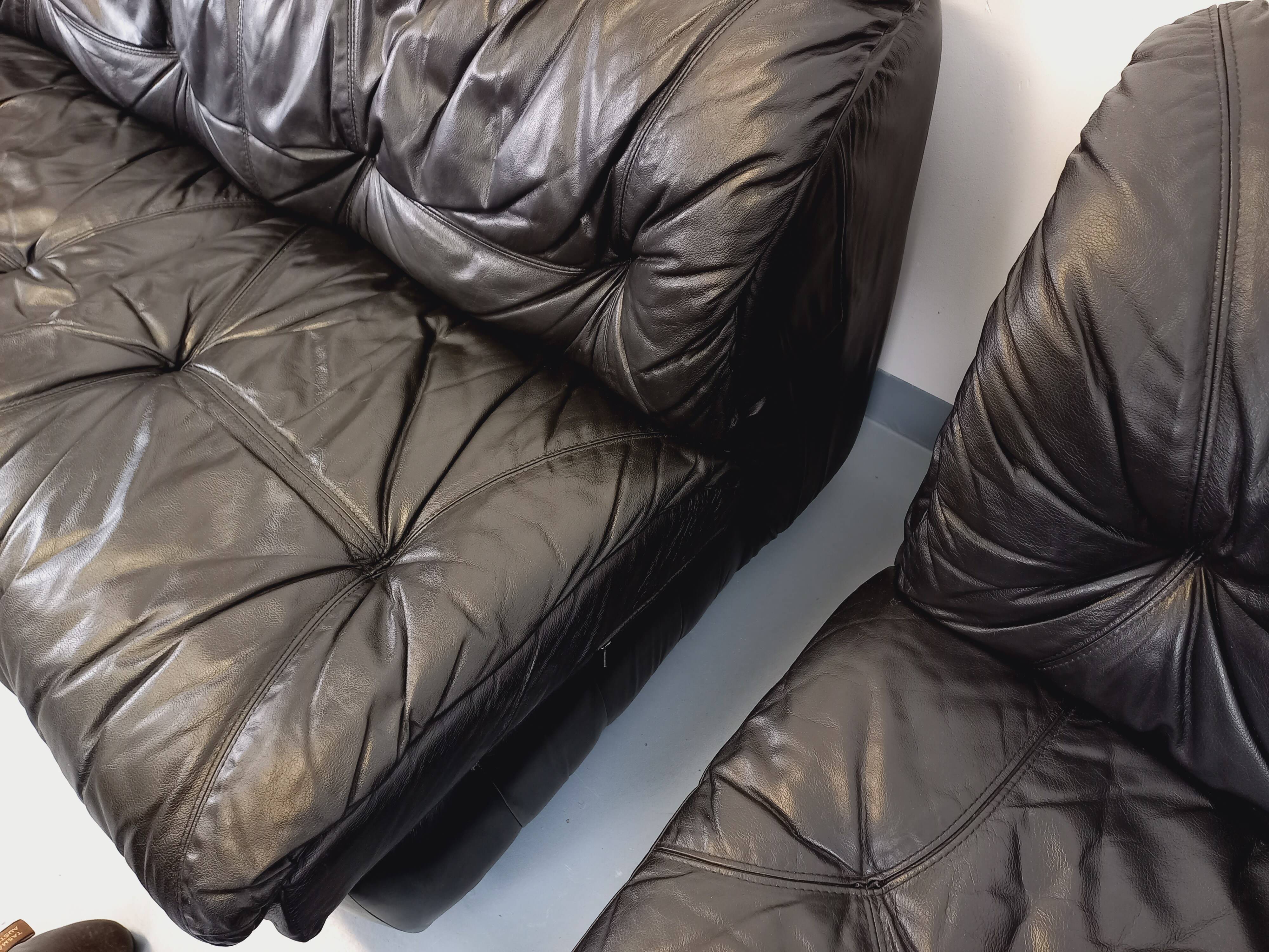 Vintage corner sofa composed of 3 modules in black leather with integrated bed.