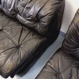 Vintage corner sofa composed of 3 modules in black leather with integrated bed.