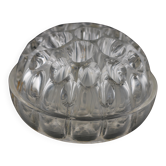 Old glass flower holder in transparent moulded glass