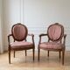 Pair of Louis XVI medallion armchairs in wood and pink fabric.