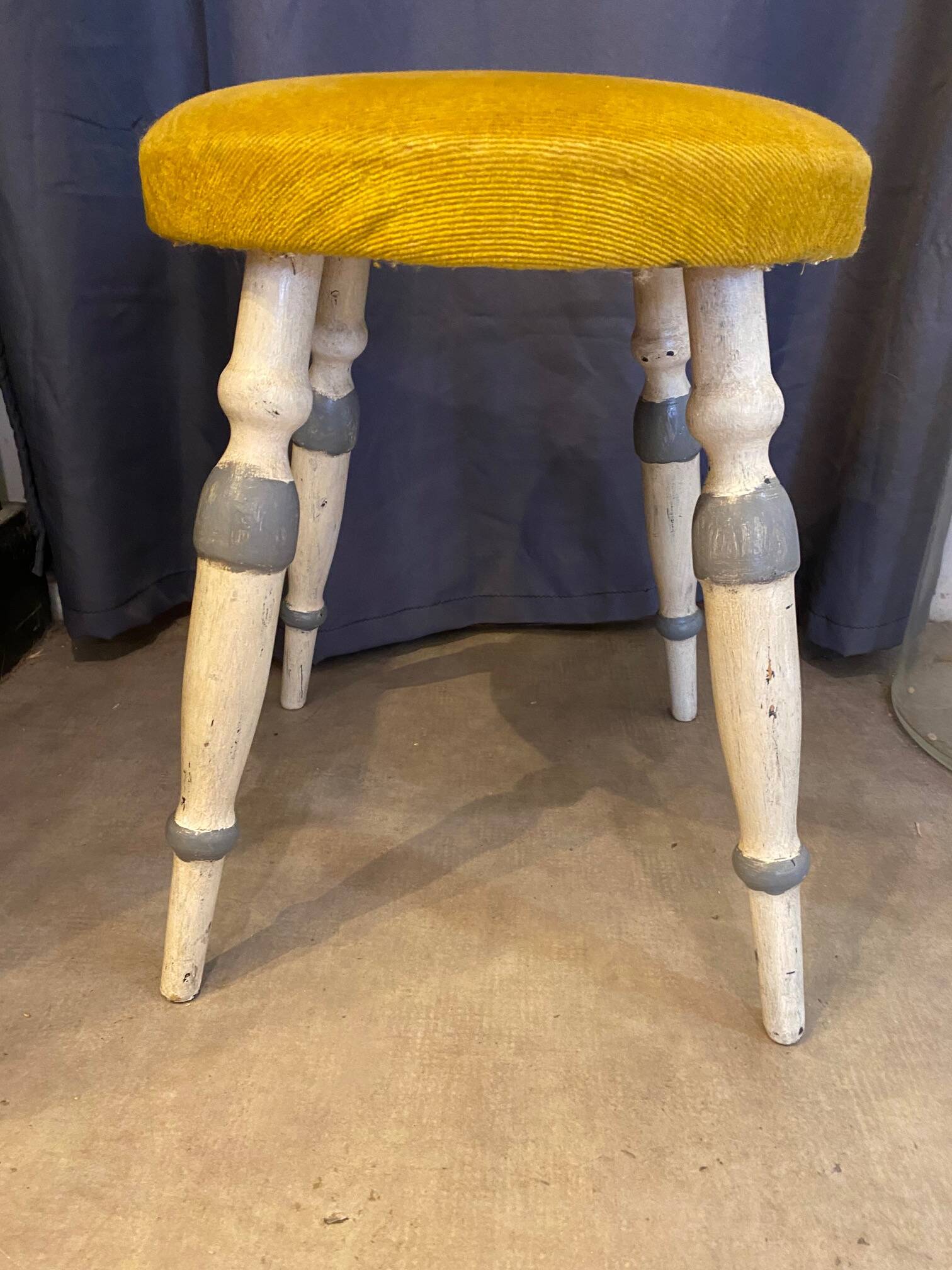 Old stool early 20th century wooden legs and round padded seat