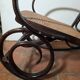 Curved wooden rocking chair with caning