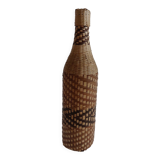 Old bottle dressed in wicker