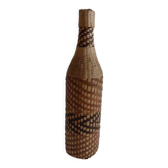 Old bottle dressed in wicker