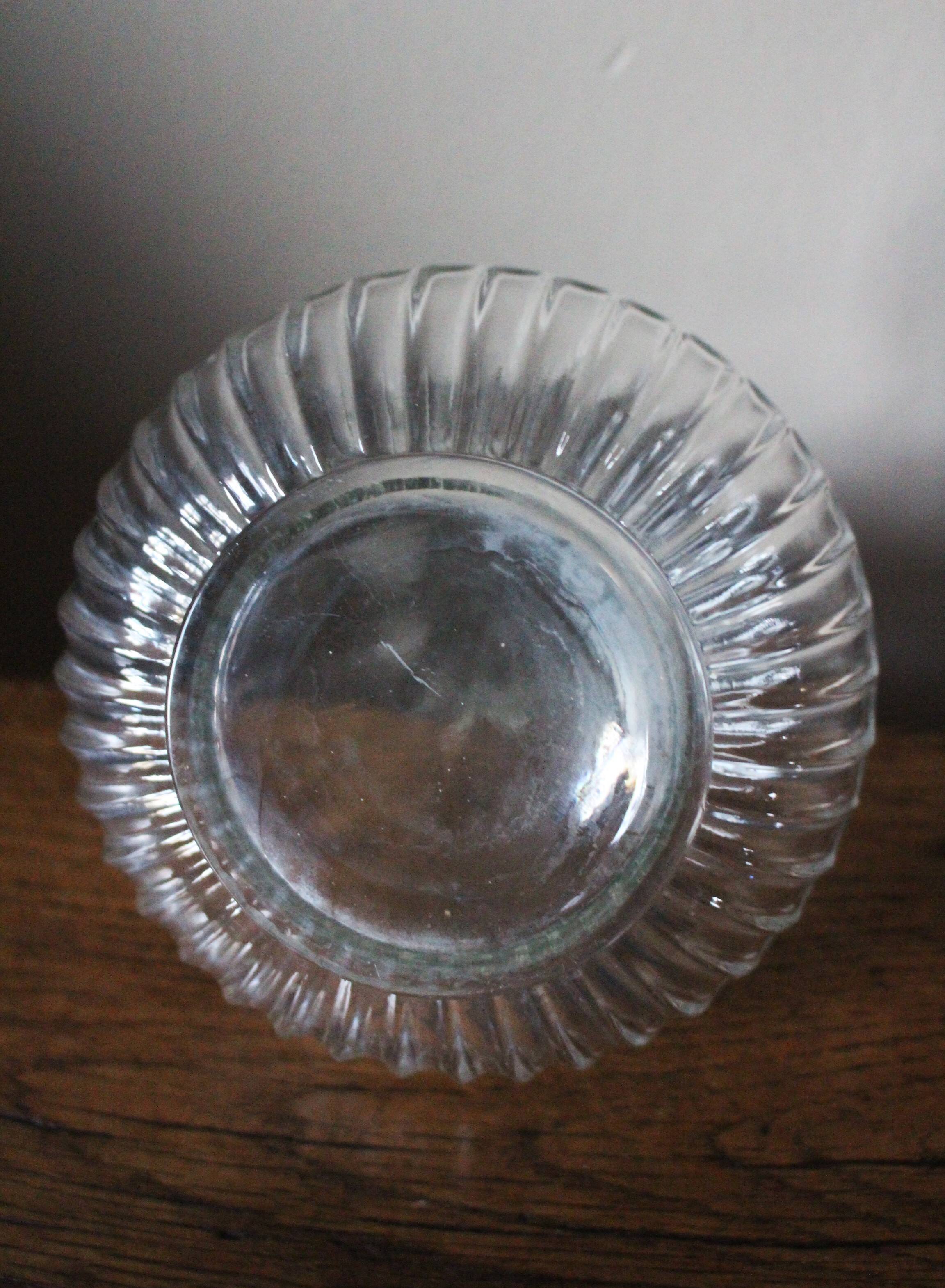 Round-bellied glass carafe with ribbed neck.