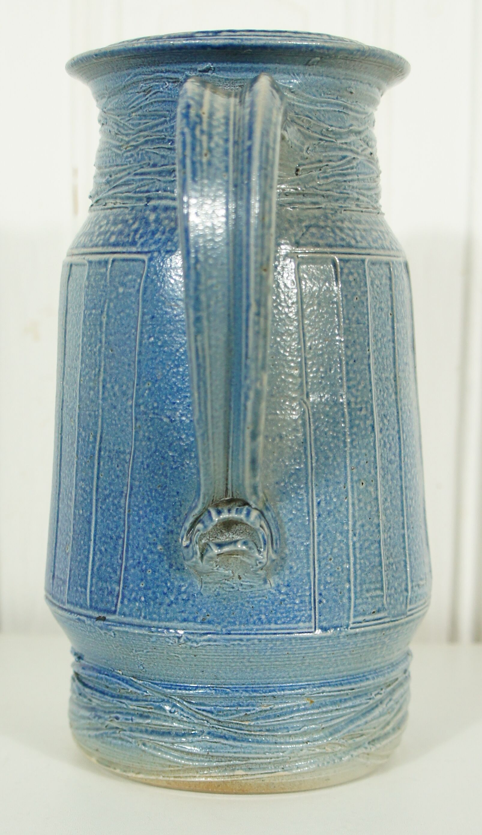 Pitcher in glazed blue sandstone signed