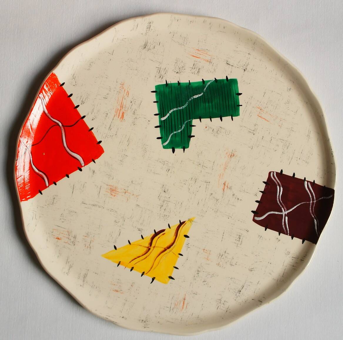 Large Longwy dish, hand-painted Harlequin model
