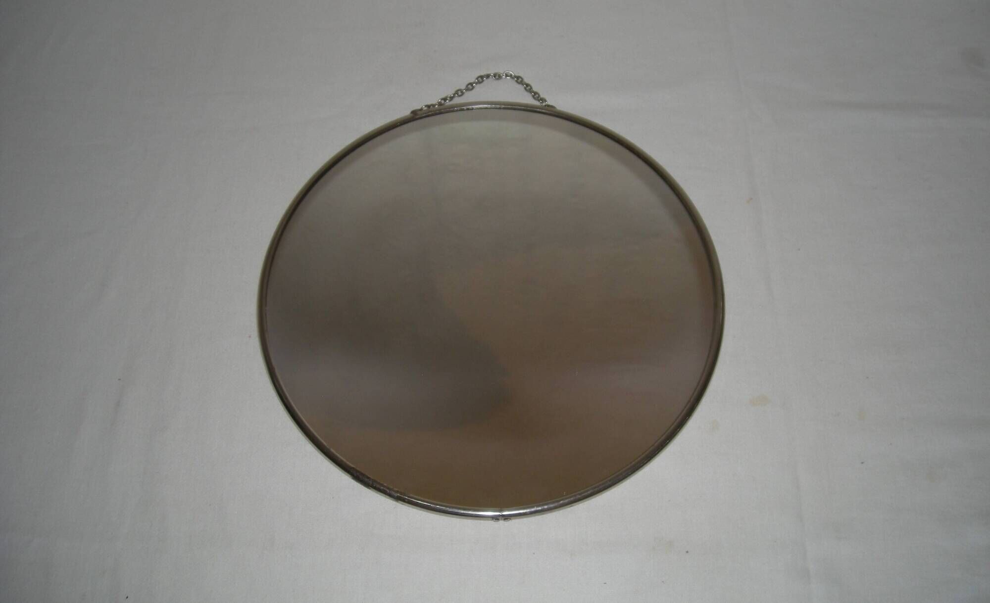 Round barber mirror with chain from the 1950s.