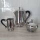 Rémy Letang / Teapot, milk jug and sugar bowl in 18/10 stainless steel and Bakelite