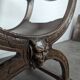 Curule chair Dagobert in carved walnut with lion heads.