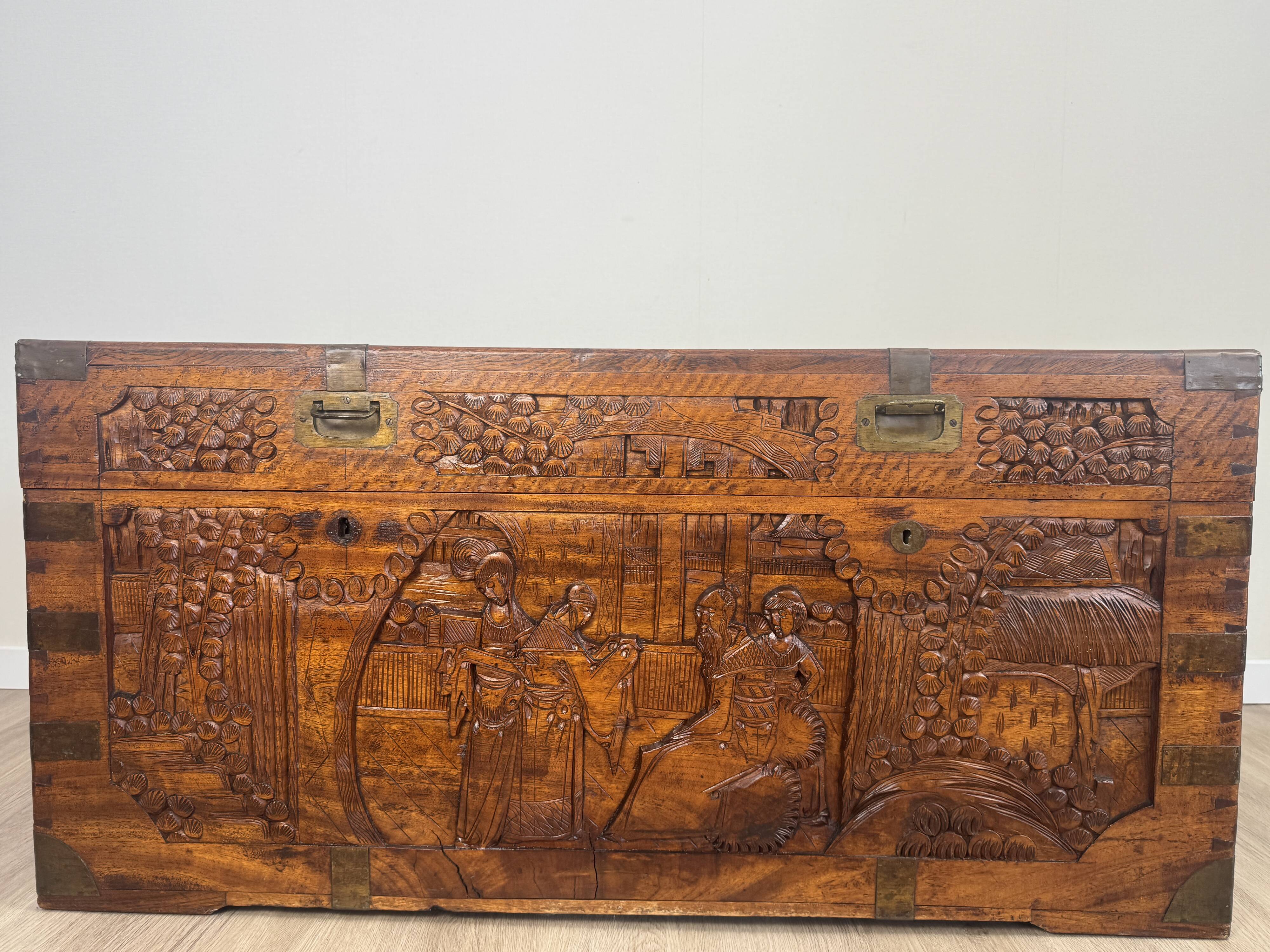Chinese carved chest made of solid wood — life scenes in bas-relief