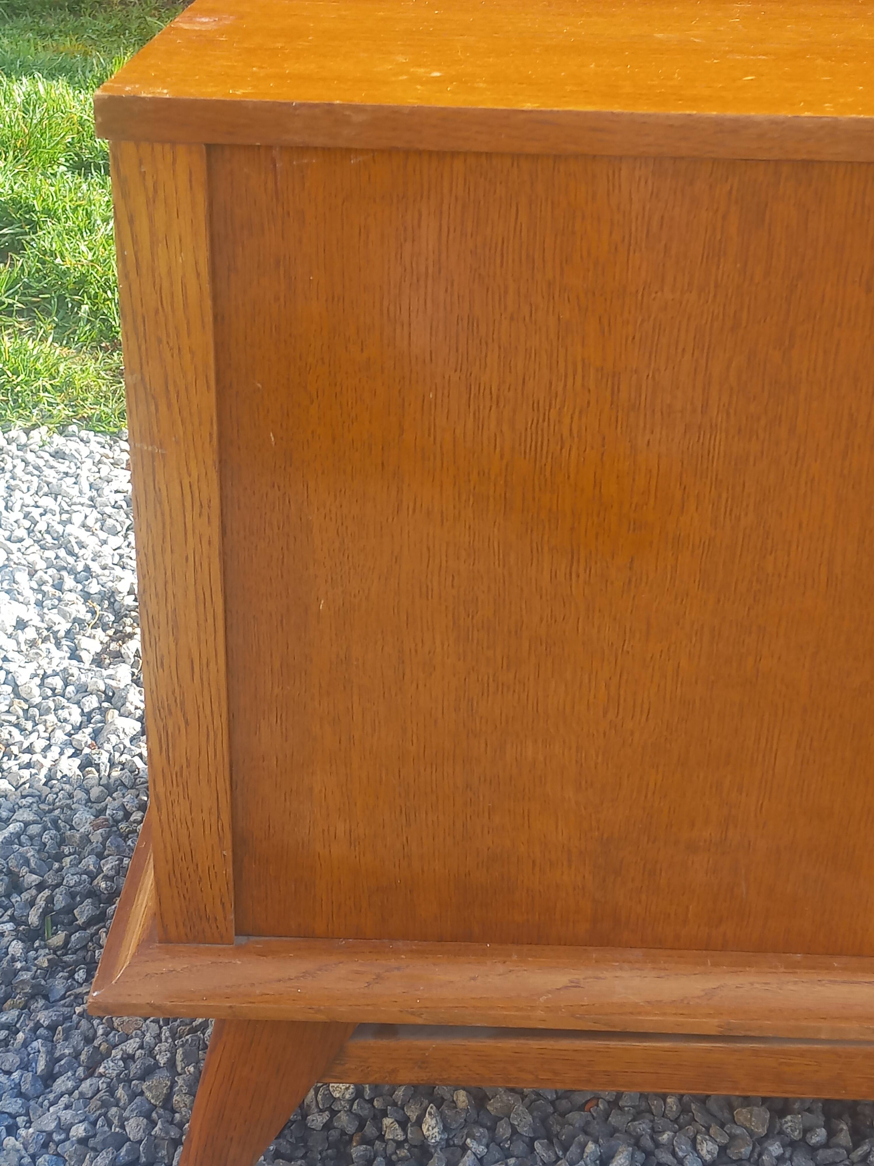 Vintage oak sideboard with splayed legs from the 1950s.