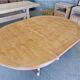 Round cherry table with 2 extensions.