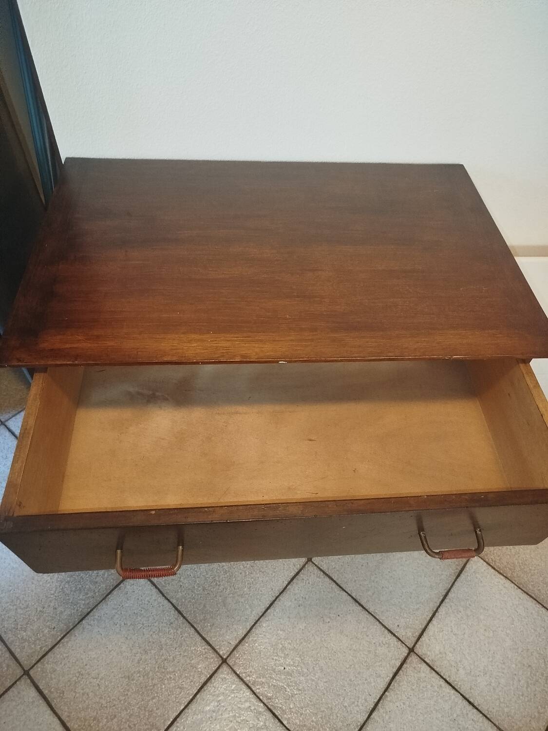Vintage chest of drawers from the 1950s with wooden legs and a design feature.