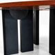 Large round dining table with black blade legs.