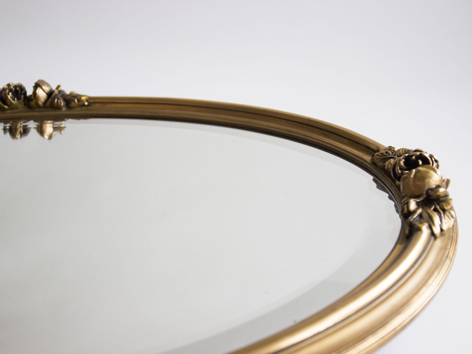 Golden oval mirror