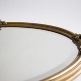 Golden oval mirror