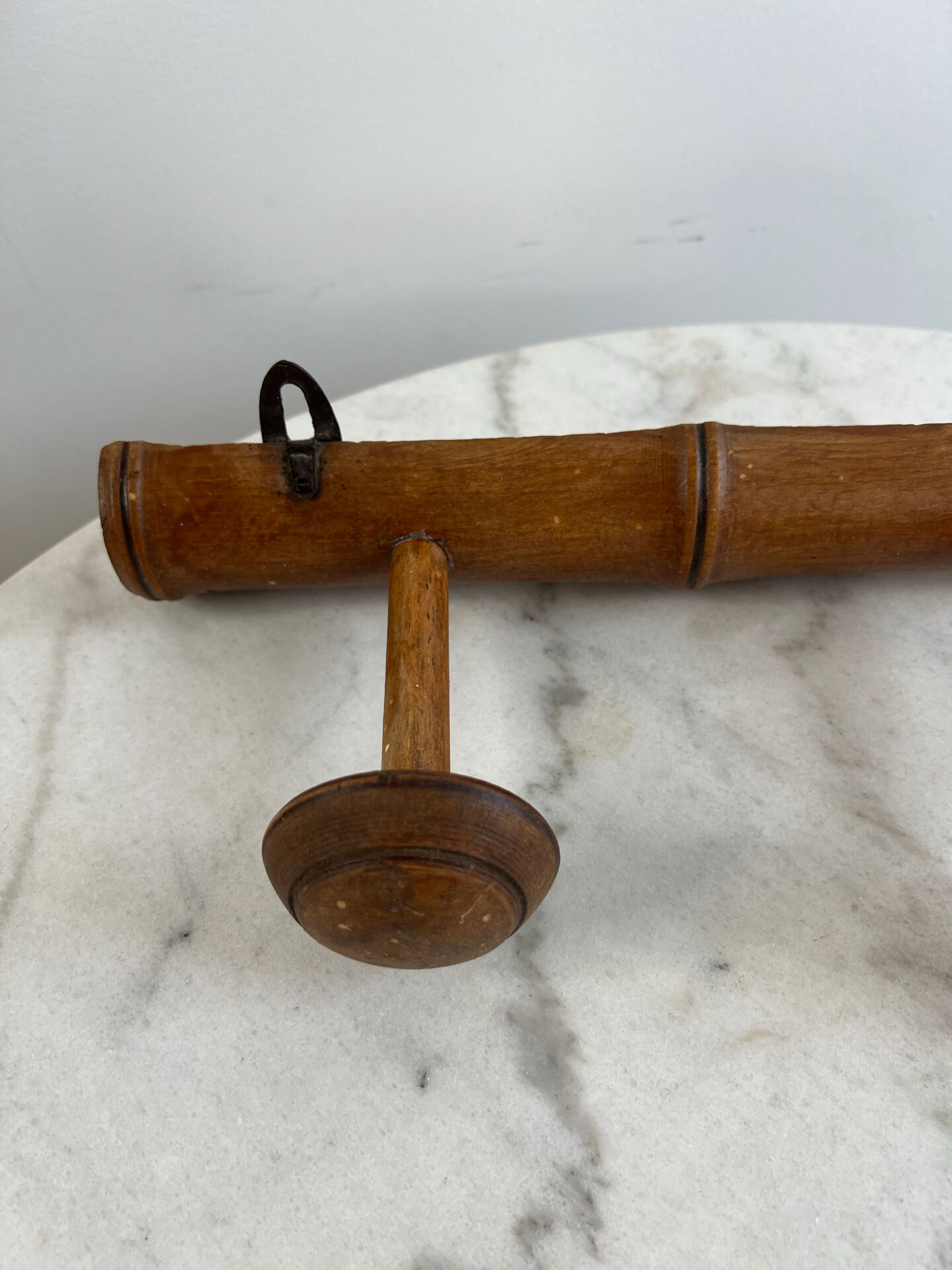 Wooden coat rack with three ball hooks.