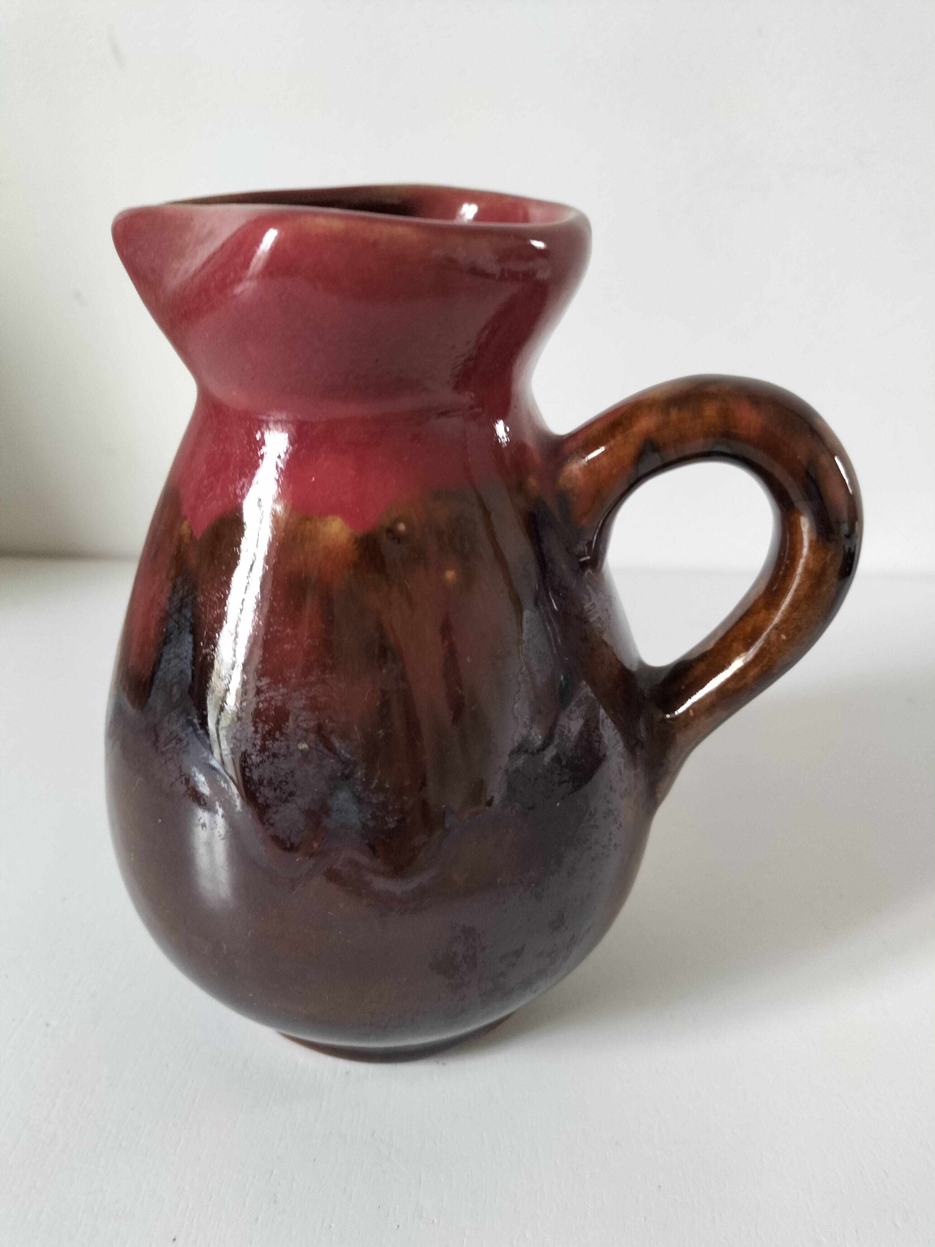 Vintage pitcher in raspberry red and chocolate flamed ceramic.