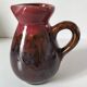 Vintage pitcher in raspberry red and chocolate flamed ceramic.