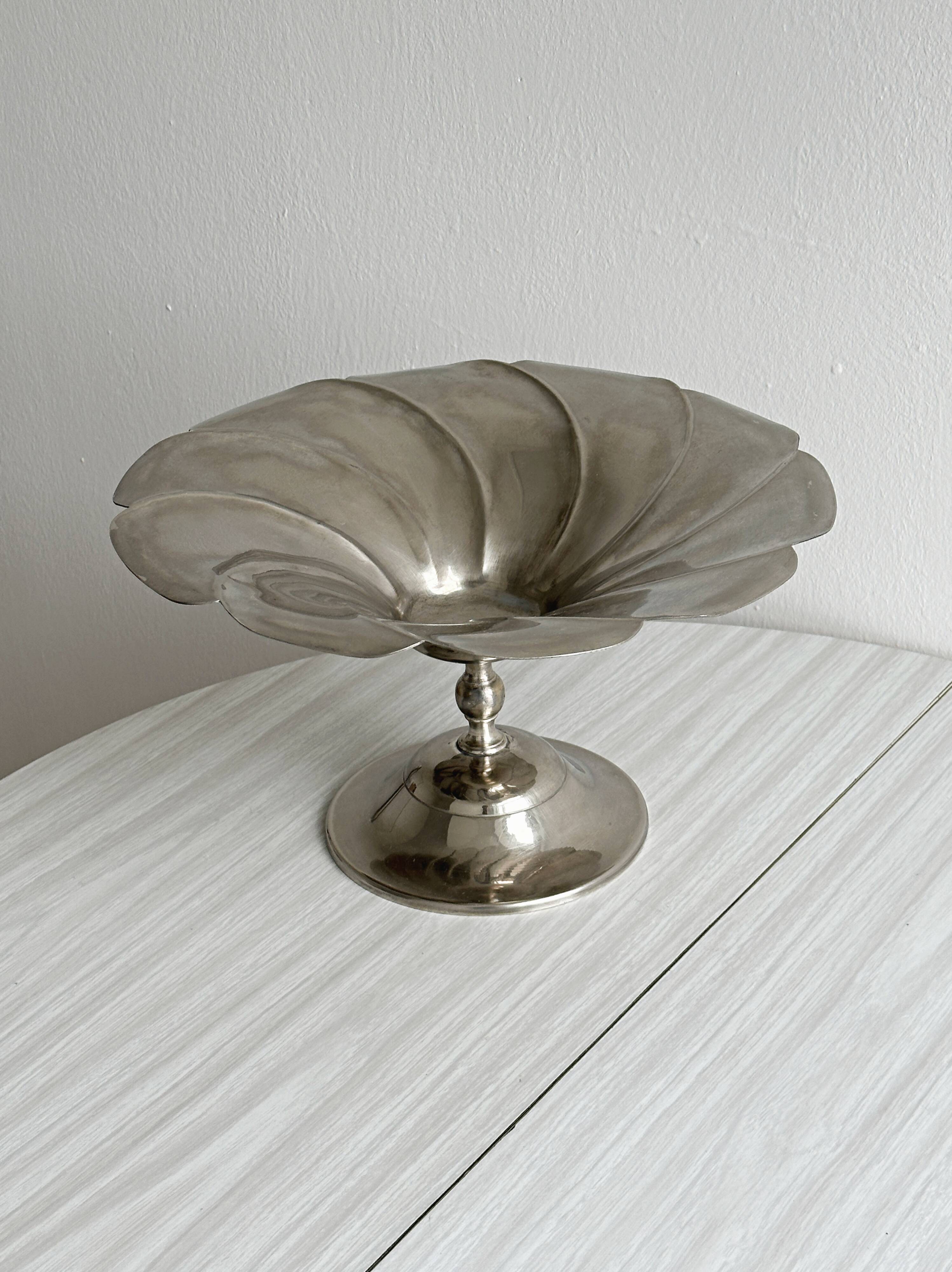 large dish on a shiny metal stand